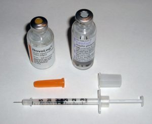 Image of insulin and syringe. Long acting Lantus and rapid-acting insulin novolog. Used for Lantus nursing considerations. 